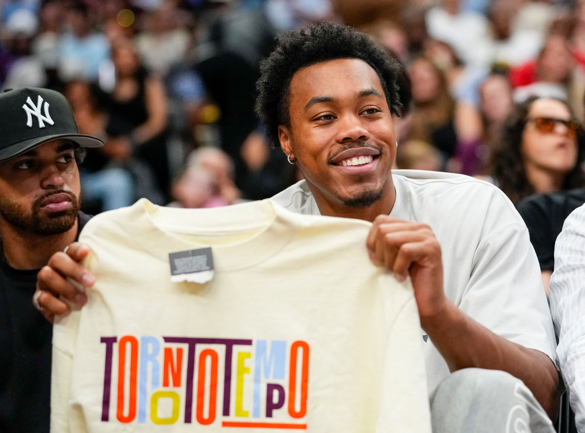 Jul 30, 2026; Toronto, Ontario, CAN; Toronto Raptors Scottie Barnes holds up a Toronto Tempo shirt during a break in play at a WNBA game against the Minnesota Lynx at Scotiabank Arena. Mandatory Credit: Kevin Sousa-Imagn Images