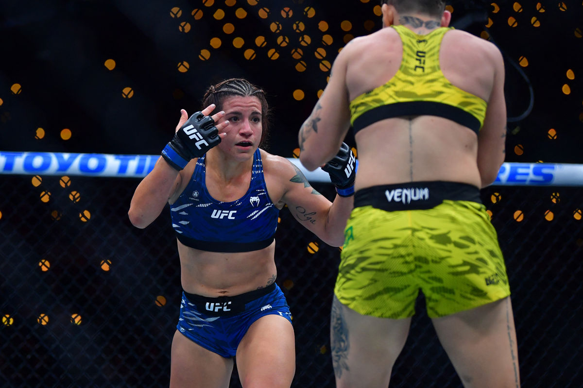 Jan 18, 2025; Inglewood, California, USA; Karol Rosa (red gloves) fights Ailin Perez (blue gloves) during UFC 311 at Intuit Dome. Mandatory Credit: Gary A. Vasquez-Imagn Images