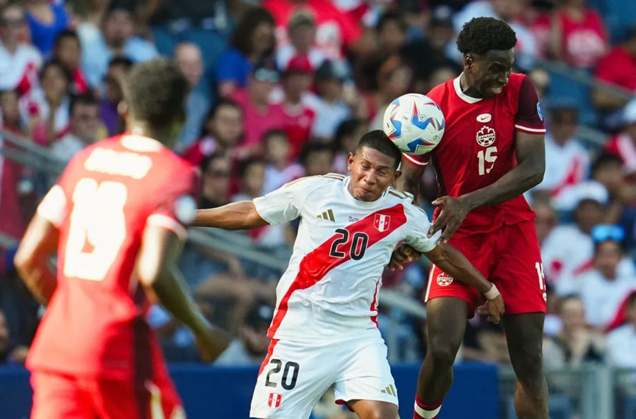 Jun 25, 2024; Kansas City, MO, USA; Peru forward Edison Flores (20) heads the ball against Canada defender Alphonso Davies (19) during the first half of a Copa America match at Children's Mercy Park. Mandatory Credit: Jay Biggerstaff-USA TODAY Sports