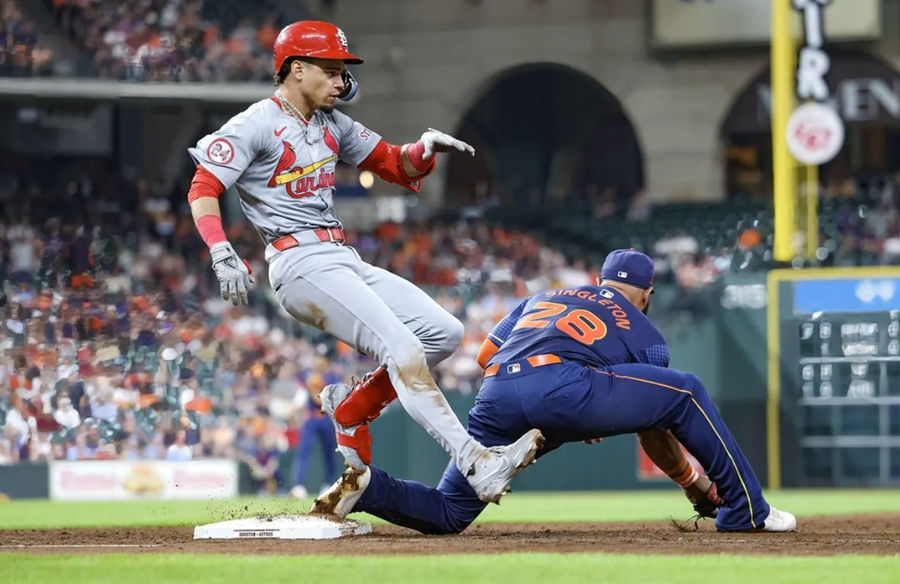 Jun 3, 2024; Houston, Texas, USA; St. Louis Cardinals shortstop Masyn Winn (0) is safe with an infield single as Houston Astros first baseman Jon Singleton (28) fields a throw during the fourth inning at Minute Maid Park. Mandatory Credit: Troy Taormina-USA TODAY Sports