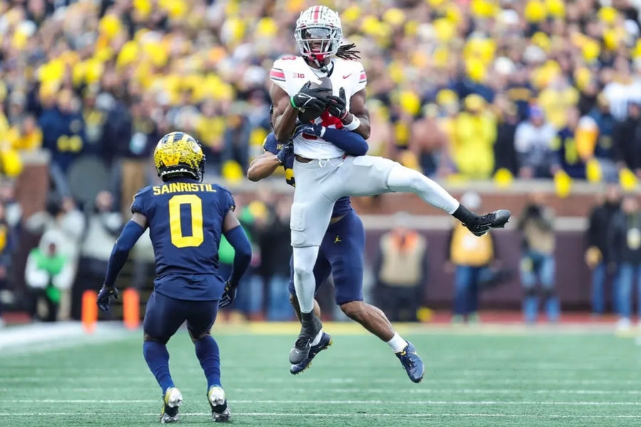 Ohio State wide receiver Marvin Harrison Jr. makes a catch against Michigan defensive backs Quinten Johnson and Mike Sainristil during the second half at Michigan Stadium in Ann Arbor on Saturday, Nov. 25, 2023. credits: Junfu Han / USA TODAY NETWORK