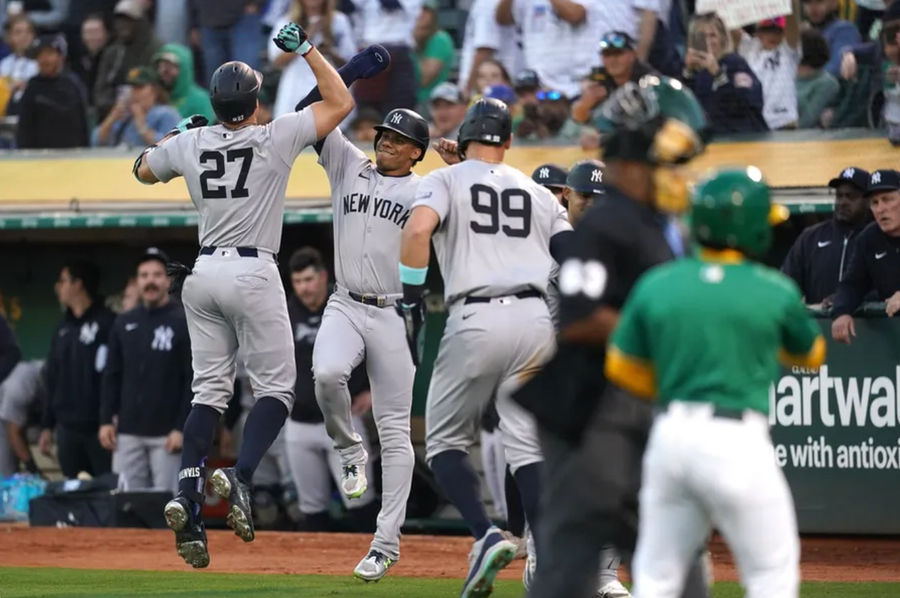 September 21, 2024; Oakland, CA, USA; New York Yankees designated hitter Giancarlo Stanton (27) during the third inning against the Oakland Athletics at the Oakland-Alameda County Coliseum was congratulated by right fielder Juan Soto (22) after hitting a three-run home run in the game. Mandatory Credit: Cary Edmondson-Imagn Images