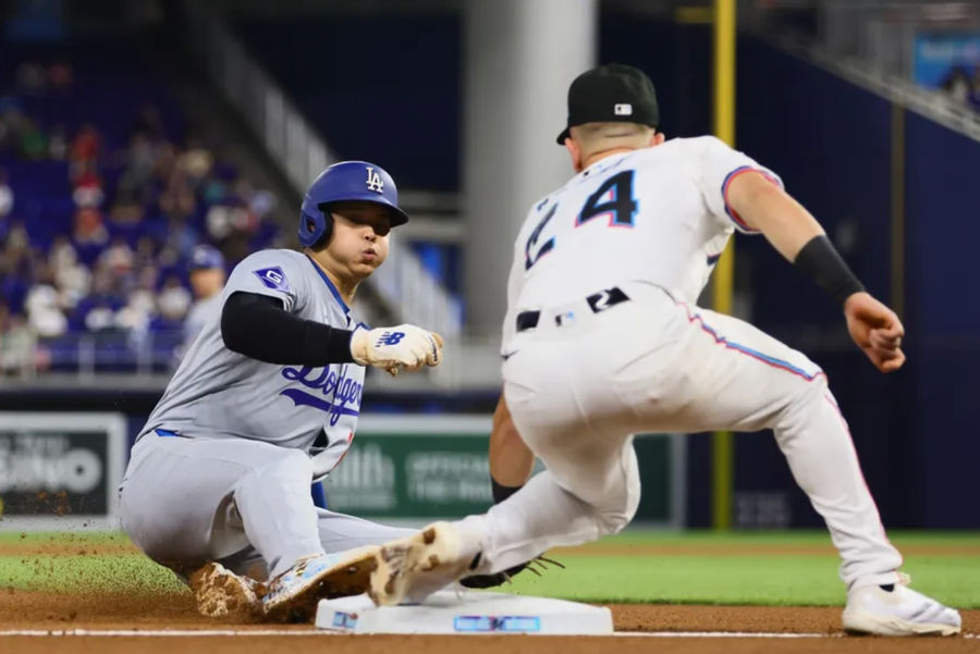 September 19, 2024; Miami, FL, USA; Los Angeles Dodgers designated hitter Shohei Ohtani (17) steals third base during the first inning against the Miami Marlins at Rental Park. Mandatory Credit: Sam Navarro-Imagn Images