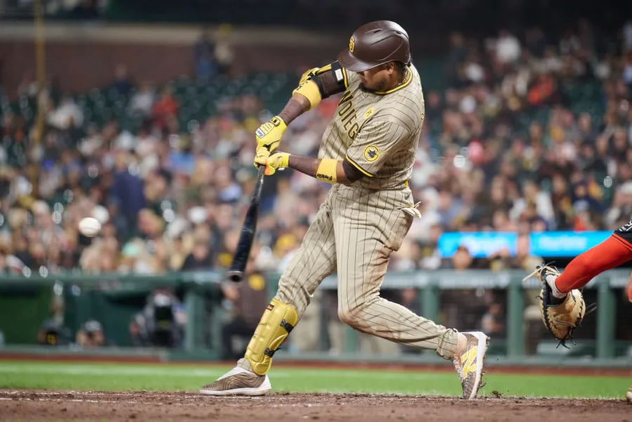 September 14, 2024; San Francisco, California, USA; San Diego Padres infielder Luis Arraez (4) hits a double against the San Francisco Giants during the eighth inning at Oracle Park. Mandatory Credit: Robert Edwards-Imagen Imagen Images