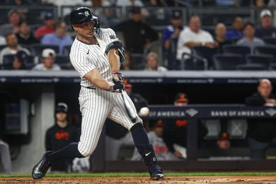 Sep 26, 2024; Bronx, New York, USA; New York Yankees designated hitter Giancarlo Stanton (27) hits a solo home run during the second inning against the Baltimore Orioles at Yankee Stadium. Mandatory Credit: Vincent Carchietta-Imagn Images