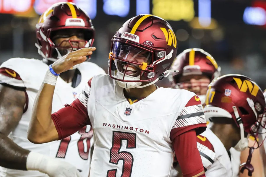 Sep 23, 2024; Cincinnati, Ohio, USA; Washington Commanders quarterback Jayden Daniels (5) reacts after scoring a touchdown against the Cincinnati Bengals in the first half at Paycor Stadium. Mandatory Credit: Katie Stratman-Imagn Images