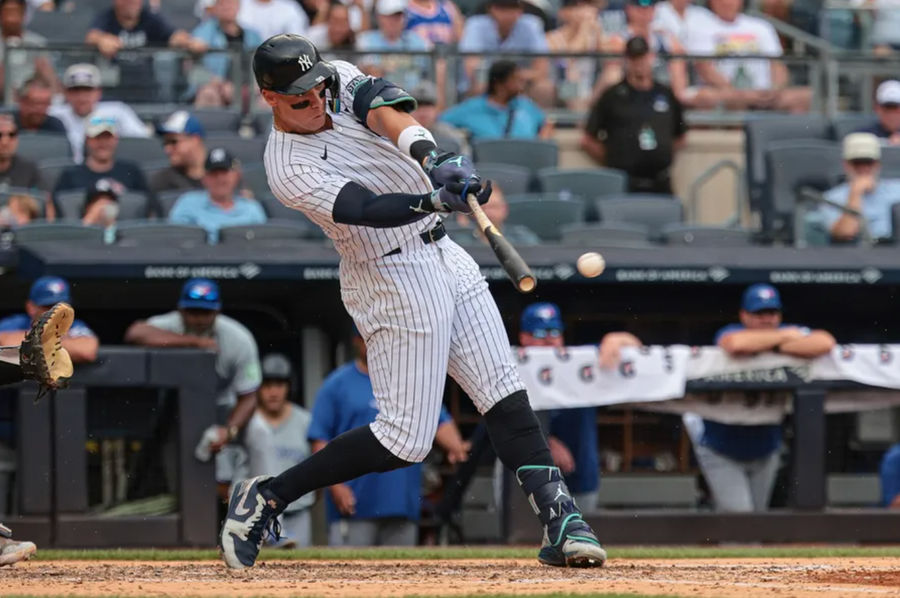 Aug 4, 2024; Bronx, New York, USA; New York Yankees left fielder Aaron Judge (99) singles during the third inning against the Toronto Blue Jays at Yankee Stadium. Mandatory Credit: Vincent Carchietta-USA TODAY Sports