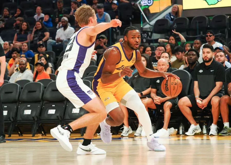 Jul 6, 2024; San Francisco, CA, USA; Los Angeles Lakers guard Bronny James Jr. (9) controls the ball against Sacramento Kings guard Dane Goodwin (33) during the third quarter at Chase Center. Mandatory Credit: Kelley L Cox-USA TODAY Sports