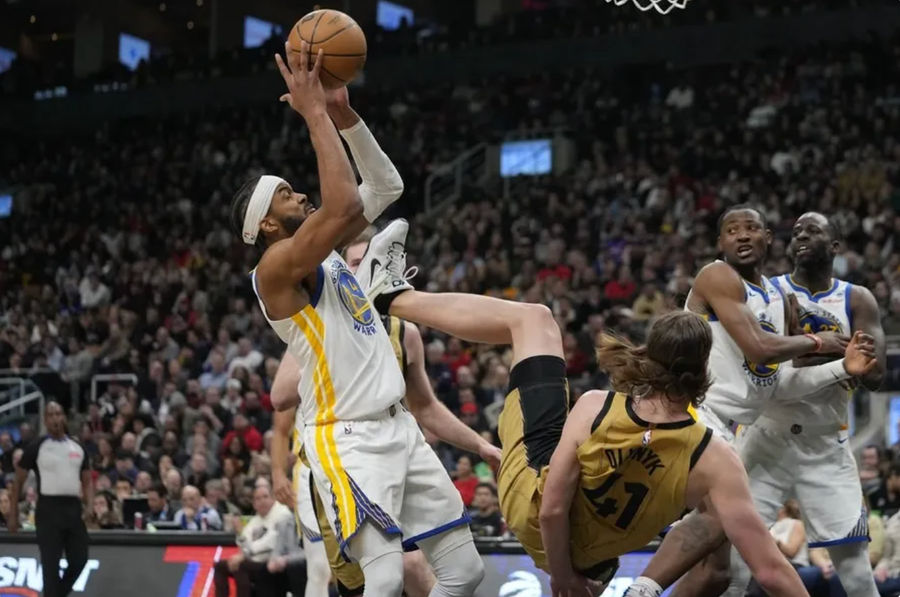 Mar 1, 2024; Toronto, Ontario, CAN; Golden State Warriors guard Moses Moody (4) comes down with a rebound as Toronto Raptors forward Kelly Olynyk (41) falls to the court during the first half at Scotiabank Arena. credits: John E. Sokolowski-USA TODAY Sports