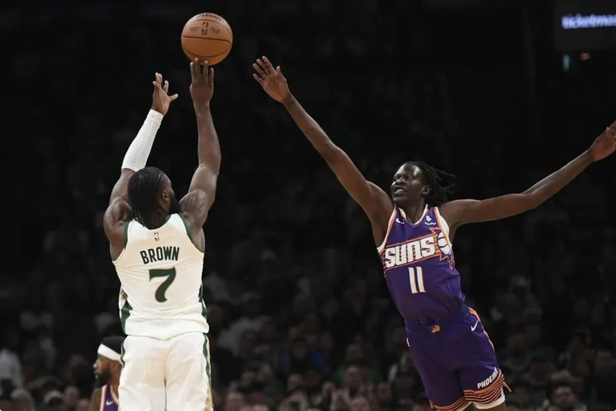 Mar 14, 2024; Boston, Massachusetts, USA; Boston Celtics guard Jaylen Brown (7) shoots the ball over Phoenix Suns center Bol Bol (11) during the first half at TD Garden. credits: Bob DeChiara-USA TODAY Sports