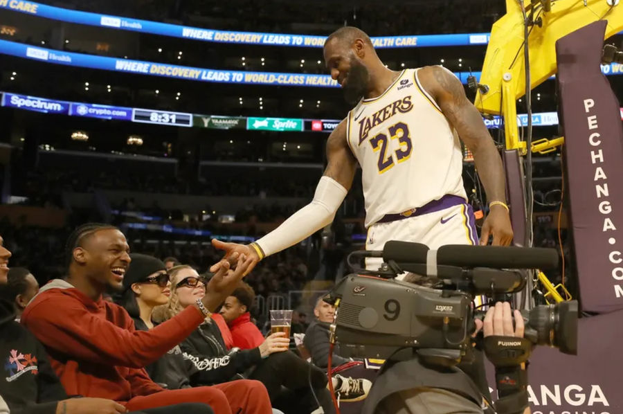 Nov 19, 2023; Los Angeles, California, USA; Los Angeles Lakers forward LeBron James (23) shakes hands with his son Bronny James during the second half against the Houston Rockets at Crypto.com Arena. Mandatory Credit: Kiyoshi Mio-Imagn Images