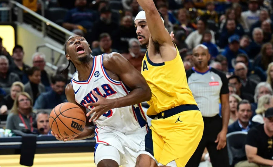 Oct 27, 2024; Indianapolis, Indiana, USA; Philadelphia 76ers guard Tyrese Maxey (0) looks up at the basket past Indiana Pacers guard Andrew Nembhard (2) during the second half at Gainbridge Fieldhouse. Mandatory Credit: Marc Lebryk-Imagn Images