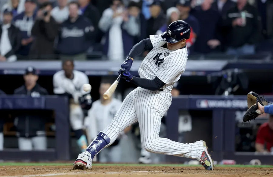 Oct 29, 2024; New York, New York, USA; New York Yankees outfielder Juan Soto (22) doubles during the eighth inning against the Los Angeles Dodgers in game four of the 2024 MLB World Series at Yankee Stadium. Mandatory Credit: Brad Penner-Imagn Images