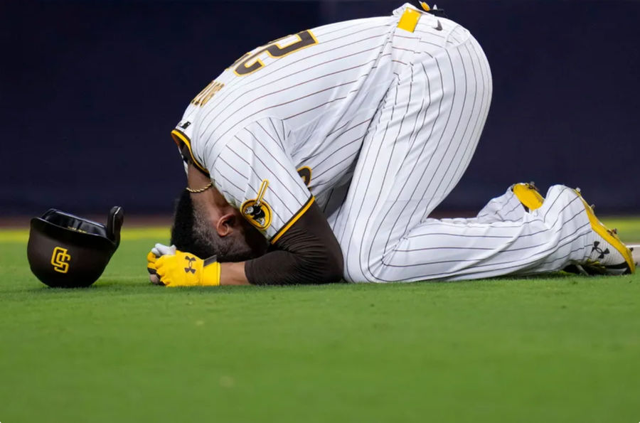 Juan Soto reacts after being hit by a foul ball while batting during the seventh inning credits: Gregory Bull | source: AP