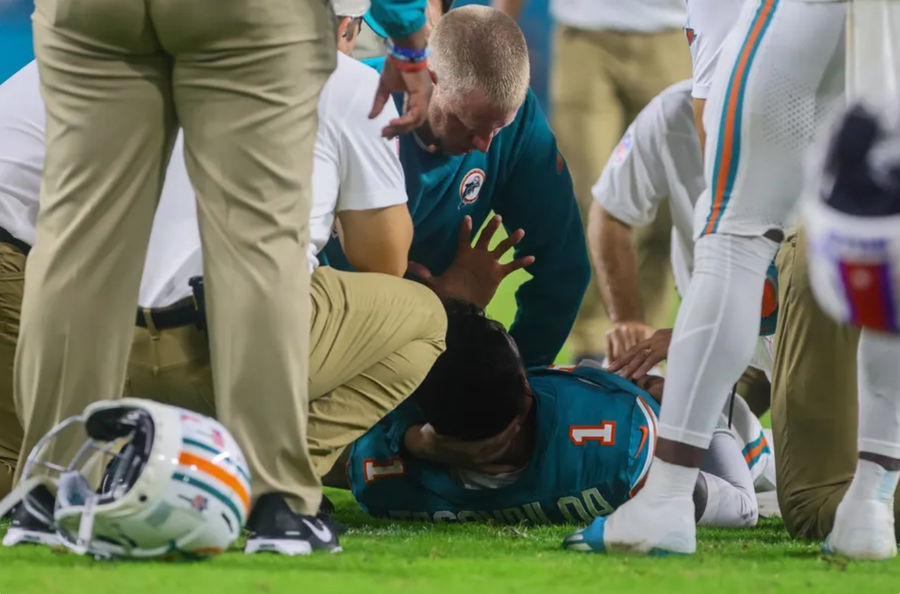 Sep 12, 2024; Miami Gardens, Florida, USA; Miami Dolphins quarterback Tua Tagovailoa (1) is checked on by trainers after an apparent injury against the Buffalo Bills during the third quarter at Hard Rock Stadium. Mandatory Credit: Sam Navarro-Imagn Images