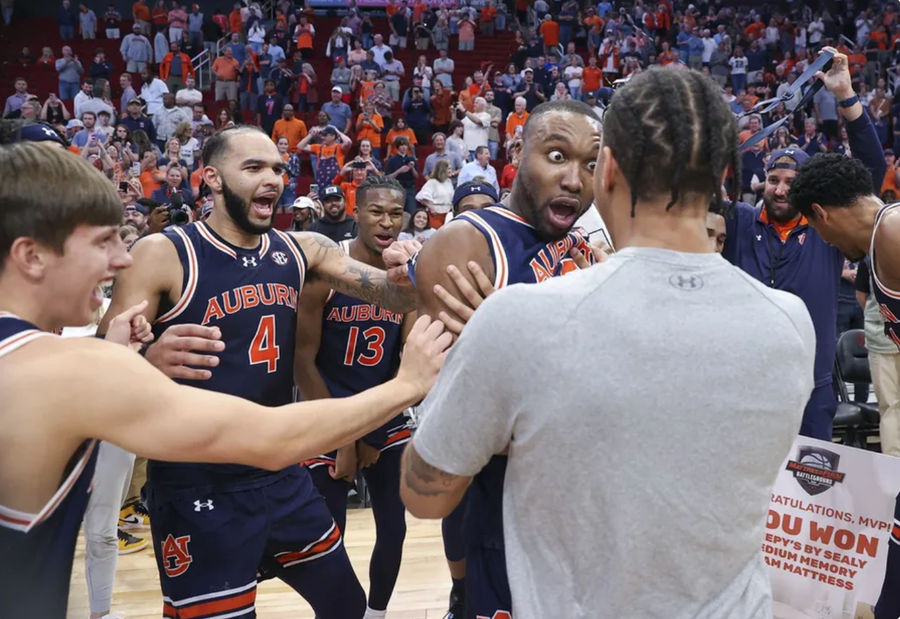 Nov 9, 2024; Houston, Texas, USA; Auburn Tigers players celebrate after the game against the Houston Cougars at Toyota Center. Mandatory Credit: Troy Taormina-Imagn Images