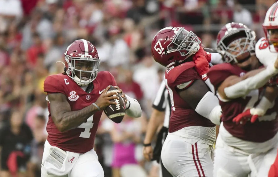 Aug 31, 2024; Tuscaloosa, Alabama, USA; Alabama Crimson Tide quarterback Jalen Milroe (4) scrambles behind blocking by offensive lineman Elijah Pritchett (57) during the first half at Bryant-Denny Stadium. Mandatory Credit: Gary Cosby Jr.-USA TODAY Sports