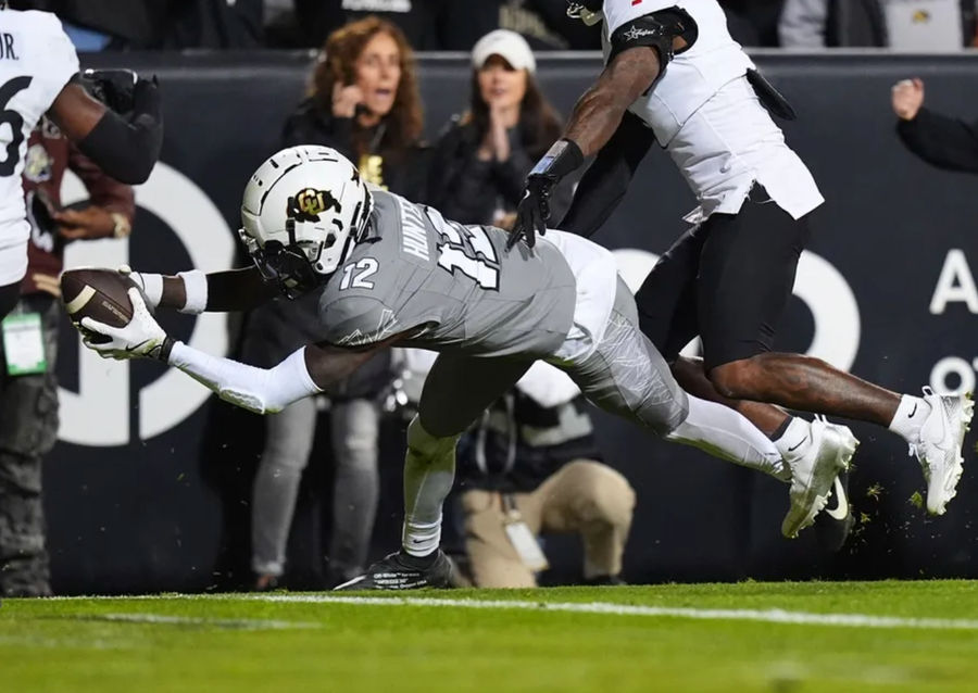 Oct 26, 2024; Boulder, Colorado, USA; Colorado Buffaloes wide receiver Travis Hunter (12) dives for a touchdown in the second quarter against the Cincinnati Bearcats at Folsom Field. Mandatory Credit: Ron Chenoy-Imagn Images