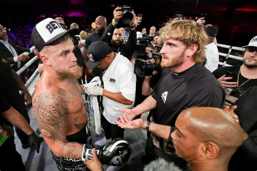 Dec 15, 2023; Orlando, Florida, USA; Jake Paul is congratulated by Logan Paul after knocking out Andre August in the first round at the Caribe Royale Orlando. Mandatory Credit: Nathan Ray Seebeck-USA TODAY Sports