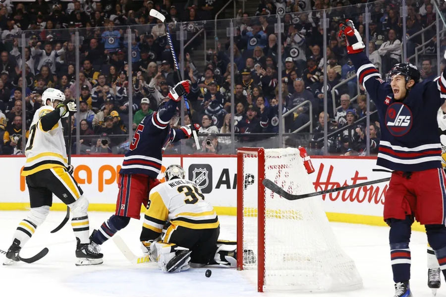 Oct 20, 2024; Winnipeg, Manitoba, CAN; Winnipeg Jets center Mark Scheifele (55) celebrates his second period goal on Pittsburgh Penguins goaltender Alex Nedeljkovic (39) with teammate Winnipeg Jets center Gabriel Vilardi (13) at Canada Life Centre. Mandatory Credit: James Carey Lauder-Imagn Images