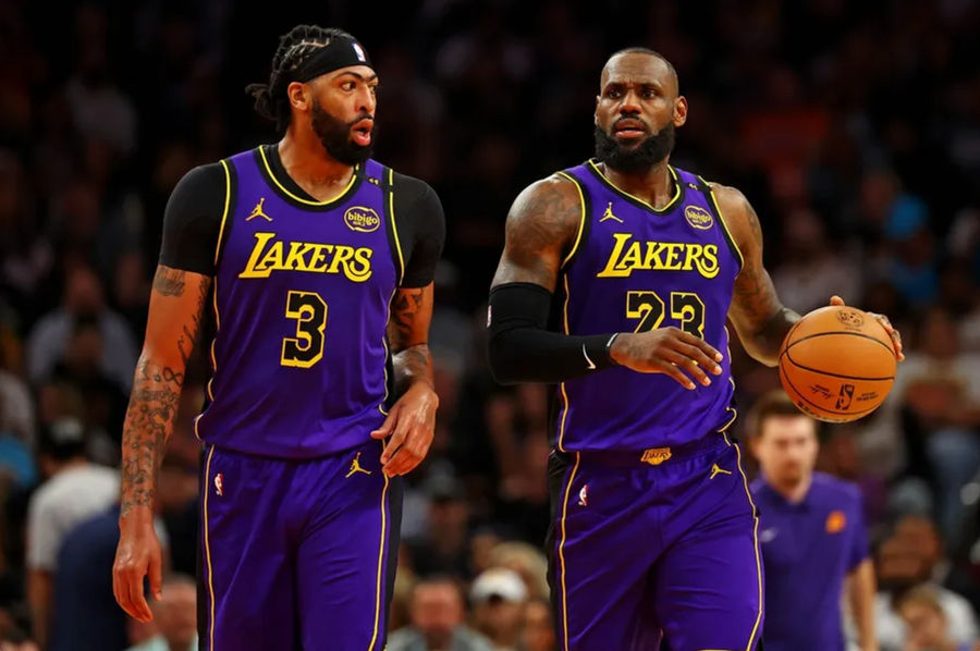 Oct 28, 2024; Phoenix, Arizona, USA; Los Angeles Lakers forward Anthony Davis (3) and forward LeBron James (23) walks to the bench during the first half against the Phoenix Suns at Footprint Center. Mandatory Credit: Mark J. Rebilas-Imagn Images