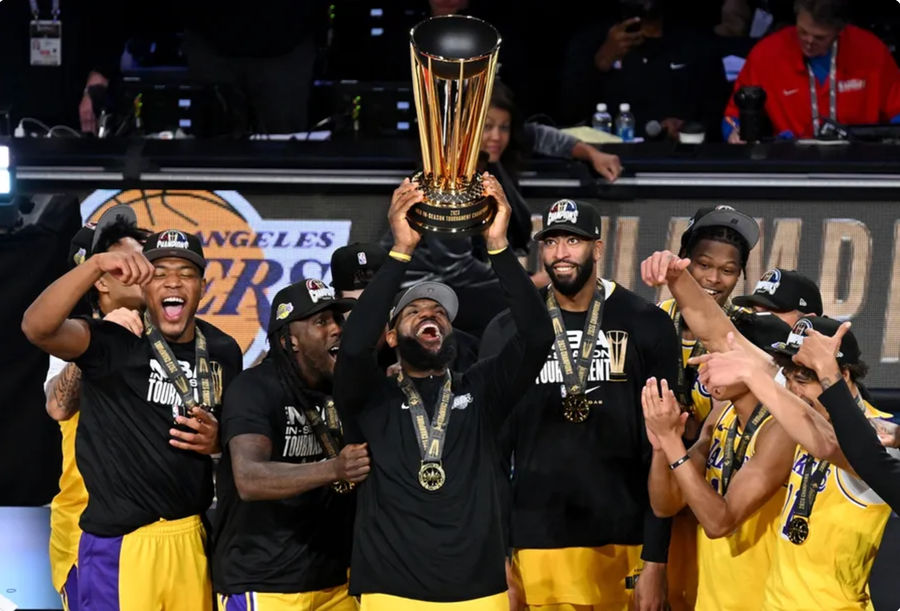 Dec 9, 2023; Las Vegas, Nevada, USA; Los Angeles Lakers forward LeBron James (23) hoists the NBA Cup and celebrates with teammates after winning the NBA In-Season Tournament Championship game against the Indiana Pacers at T-Mobile Arena. Mandatory Credit: Candice Ward-Imagn Images