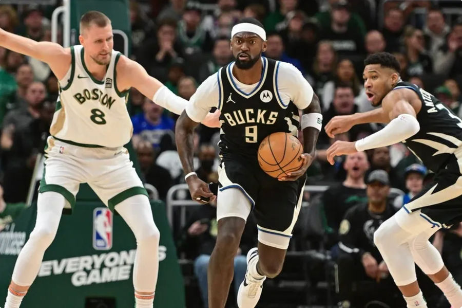 Jan 11, 2024; Milwaukee, Wisconsin, USA; Milwaukee Bucks forward Bobby Portis (9) brings the ball down court against Boston Celtics center Kristaps Porzingis (8) in the second quarterat Fiserv Forum. credits: Benny Sieu-USA TODAY Sports