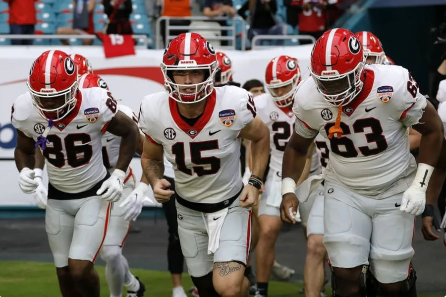 Dec 30, 2023; Miami Gardens, FL, USA; Georgia Bulldogs quarterback Carson Beck (15) leads the team onto the field before the game against the Florida State Seminoles for the 2023 Orange Bowl at Hard Rock Stadium. credits: Sam Navarro-USA TODAY Sports