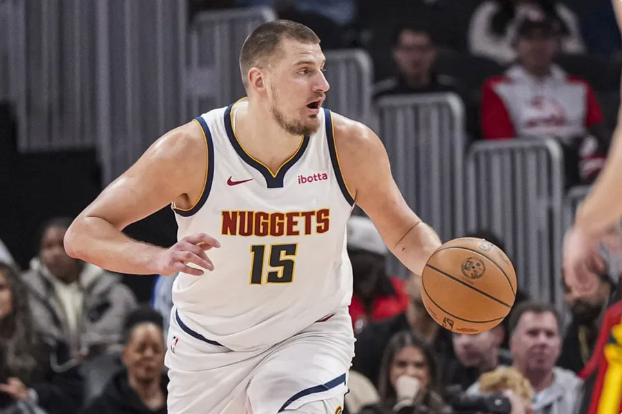 Dec 8, 2024; Atlanta, Georgia, USA; Denver Nuggets center Nikola Jokic (15) controls the ball against the Atlanta Hawks during the first half at State Farm Arena. Mandatory Credit: Dale Zanine-Imagn Images