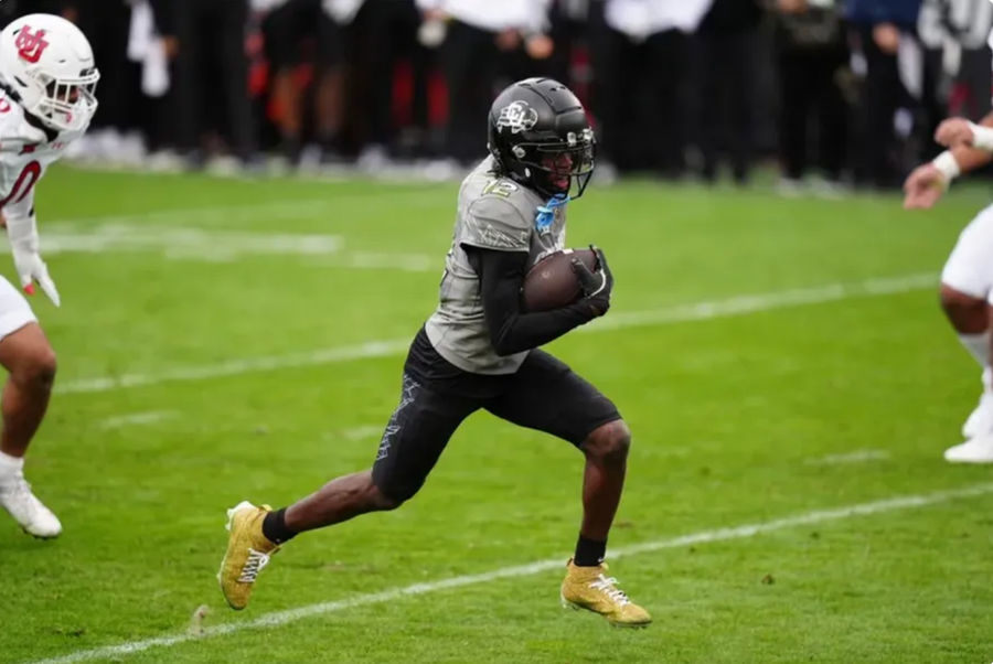 Nov 16, 2024; Boulder, Colorado, USA; Colorado Buffaloes wide receiver Travis Hunter (12) carries for a touchdown in the fourth quarter against the Utah Utes at Folsom Field. Mandatory Credit: Ron Chenoy-Imagn Images