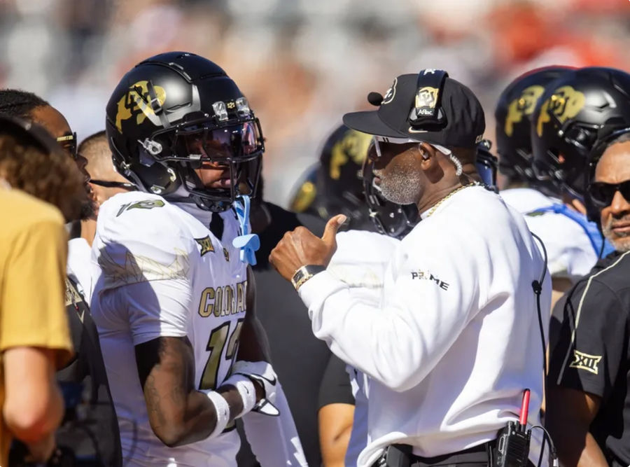 Oct 19, 2024; Tucson, Arizona, USA; Colorado Buffalos wide receiver Travis Hunter (12) with head coach Deion Sanders against the Arizona Wildcats at Arizona Stadium. Mandatory Credit: Mark J. Rebilas-Imagn Images