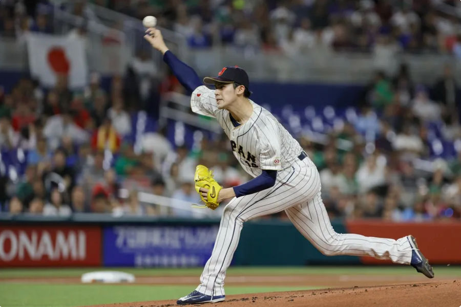 Mar 20, 2023; Miami, Florida, USA; Japan starting pitcher Roki Sasaki (14) delivers a pitch during the first inning against Mexico at LoanDepot Park. Mandatory Credit: Sam Navarro-Imagn Images