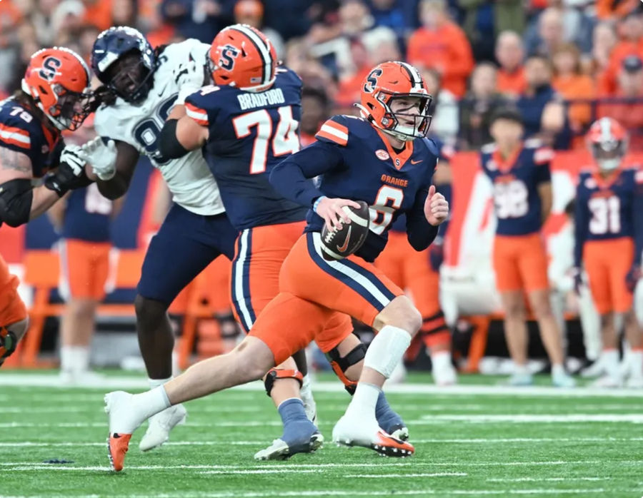 Nov 23, 2024; Syracuse, New York, USA; Syracuse Orange quarterback Kyle McCord (6) runs out of the pocket in the first quarter against the Connecticut Huskies at the JMA Wireless Dome. Mandatory Credit: Mark Konezny-Imagn Images