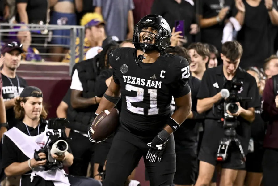 Oct 26, 2024; College Station, Texas, USA; Texas A&M Aggies linebacker Taurean York (21) reacts after catching the ball for an interception in the fourth quarter against the LSU Tigers at Kyle Field. Mandatory Credit: Maria Lysaker-Imagn Images.
