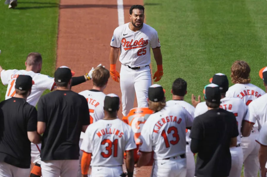 Sep 19, 2024; Baltimore, Maryland, USA; Baltimore Orioles designated hitter Anthony Santander (25) is greeted by teammates following his game winning two run home run in the ninth inning against the San Francisco Giants at Oriole Park at Camden Yards. Mandatory Credit: Mitch Stringer-Imagn Images