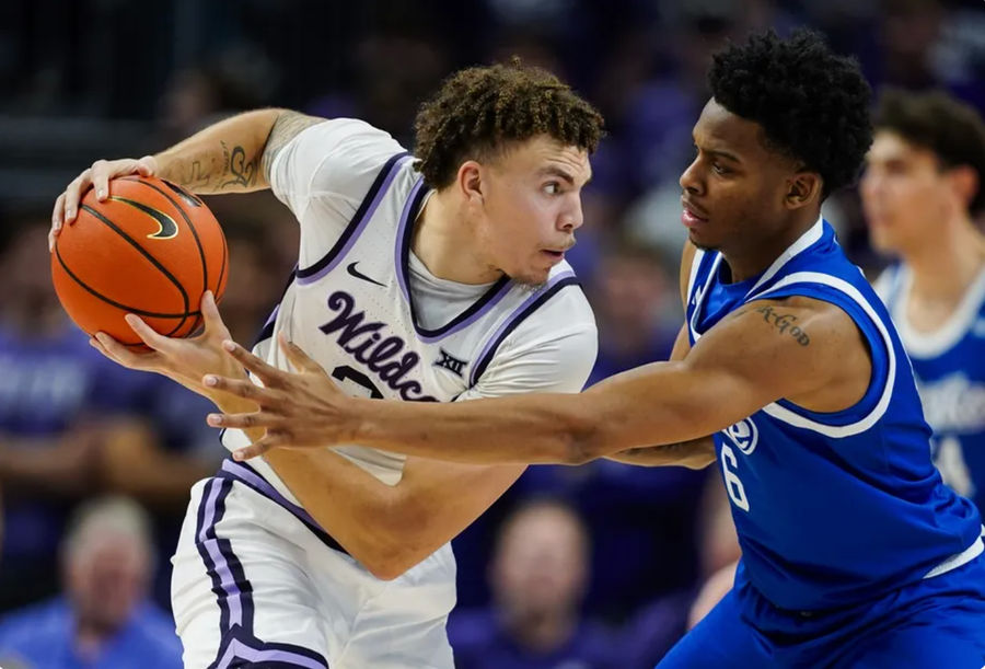 Dec 17, 2024; Kansas City, Missouri, USA; Kansas State Wildcats guard Coleman Hawkins (33) looks to pass against Drake Bulldogs guard Tavion Banks (6) during the second half at T-Mobile Center. Mandatory Credit: Jay Biggerstaff-Imagn Images