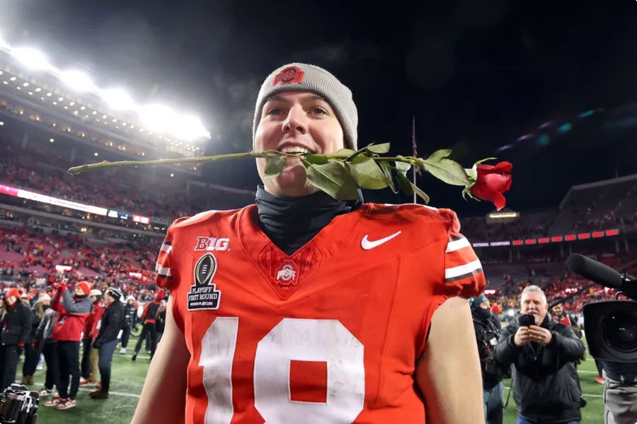 Dec 21, 2024; Columbus, Ohio, USA; Ohio State Buckeyes quarterback Will Howard (18) celebrates the win as he carries a rose after the game against the Tennessee Volunteers at Ohio Stadium. Mandatory Credit: Joseph Maiorana-Imagn Images