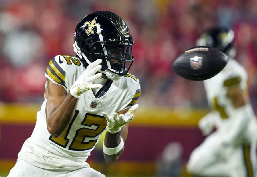 Oct 7, 2024; Kansas City, Missouri, USA; New Orleans Saints wide receiver Chris Olave (12) catches a pass during the second half against the Kansas City Chiefs at GEHA Field at Arrowhead Stadium. Mandatory Credit: Jay Biggerstaff-Imagn Images