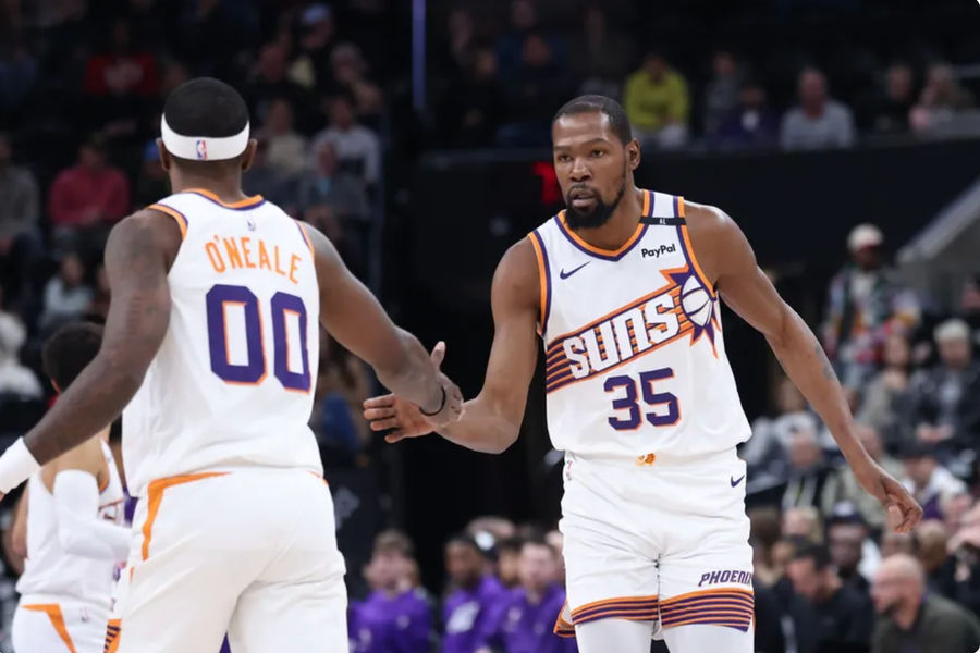 Dec 13, 2024; Salt Lake City, Utah, USA; Phoenix Suns forward Kevin Durant (35) and forward Royce O'Neale (00) react to a play against the Utah Jazz during the first quarter at Delta Center. Mandatory Credit: Rob Gray-Imagn Images