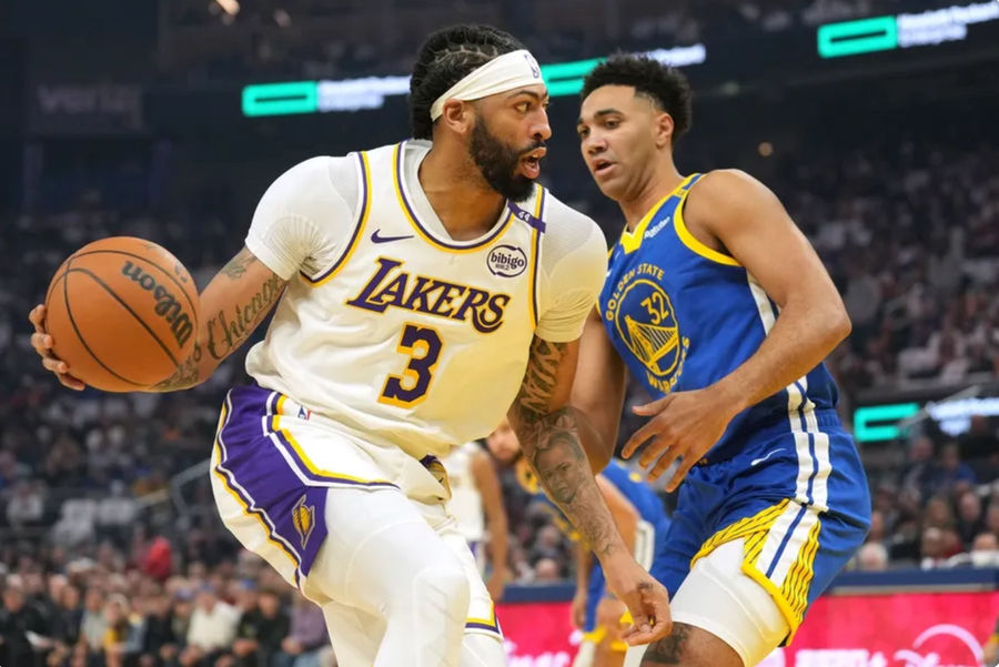 Dec 25, 2024; San Francisco, California, USA; Los Angeles Lakers forward Anthony Davis (3) dribbles against Golden State Warriors forward Trayce Jackson-Davis (32) during the first quarter at Chase Center. Mandatory Credit: Darren Yamashita-Imagn Images