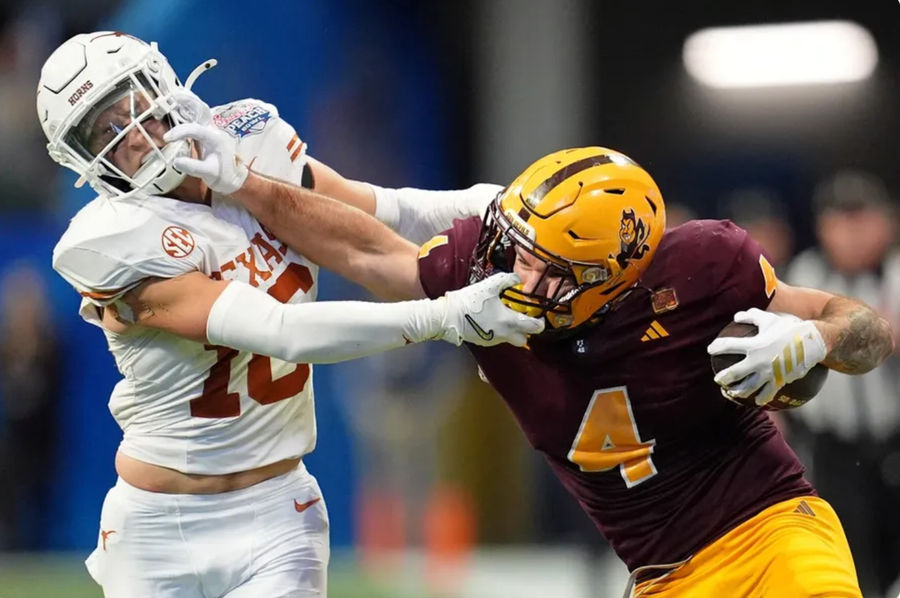 Jan 1, 2025; Atlanta, GA, USA; Arizona State Sun Devils running back Cam Skattebo (4) and Texas Longhorns defensive back Michael Taaffe (16) push each other during the second half of the Peach Bowl at Mercedes-Benz Stadium. Mandatory Credit: Dale Zanine-Imagn Images