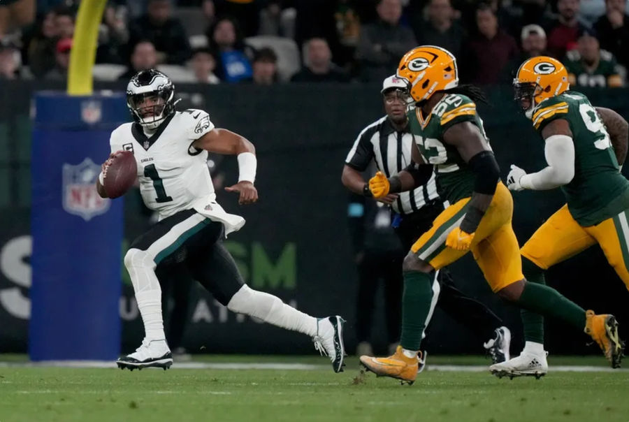 Sep 6, 2024; Sao Paulo, BRA; Philadelphia Eagles quarterback Jalen Hurts (1) scrambles against Green Bay Packers defensive end Rashan Gary (52) during the first half at Neo Quimica Arena. Mandatory Credit: Kirby Lee-Imagn Images