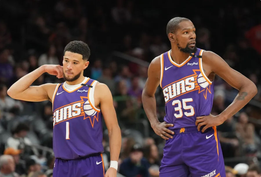 Nov 27, 2024; Phoenix, Arizona, USA; Phoenix Suns guard Devin Booker (1) and Phoenix Suns forward Kevin Durant (35) look on against the Brooklyn Nets during the second half at Footprint Center. Mandatory Credit: Joe Camporeale-Imagn Images