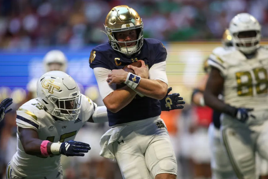 Oct 19, 2024; Atlanta, Georgia, USA; Notre Dame Fighting Irish quarterback Riley Leonard (13) runs the ball for a touchdown against the Georgia Tech Yellow Jackets in the second quarter at Mercedes-Benz Stadium. Mandatory Credit: Brett Davis-Imagn Images