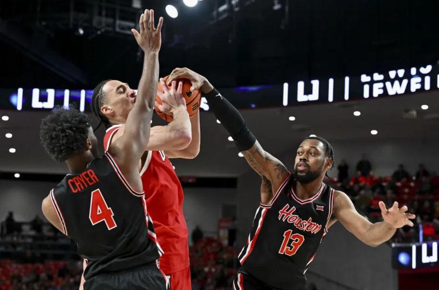 Jan 22, 2025; Houston, Texas, USA; Utah Utes forward Keanu Dawes (8) attempts to shoot as Houston Cougars forward J'Wan Roberts (13) and guard L.J. Cryer (4) defends during the second half at Fertitta Center. The Cougars defeated the Utes 70-36. Mandatory Credit: Maria Lysaker-Imagn Images