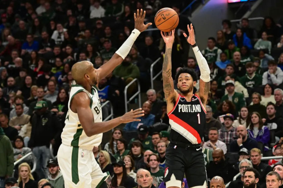 Jan 4, 2025; Milwaukee, Wisconsin, USA; Portland Trail Blazers guard Anfernee Simons (1) takes a shot against Milwaukee Bucks forward Khris Middleton (22) in he second quarter at Fiserv Forum. Mandatory Credit: Benny Sieu-Imagn Images