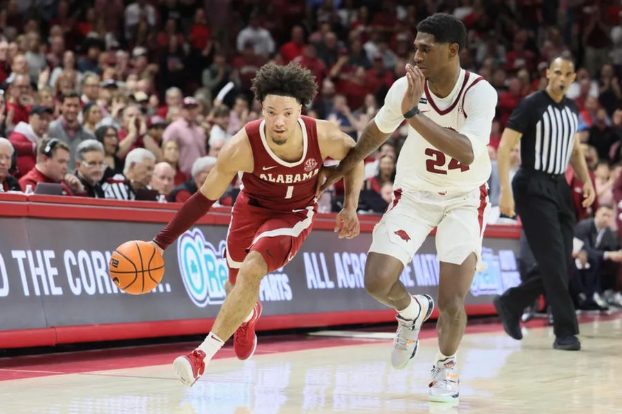 Feb 8, 2025; Fayetteville, Arkansas, USA; Alabama Crimson Tide guard mark Sears (1) drives against Arkansas Razorbacks forward Billy Richmond III (24) during the second half at Bud Walton Arena. Alabama won 85-81. Mandatory Credit: Nelson Chenault-Imagn Images