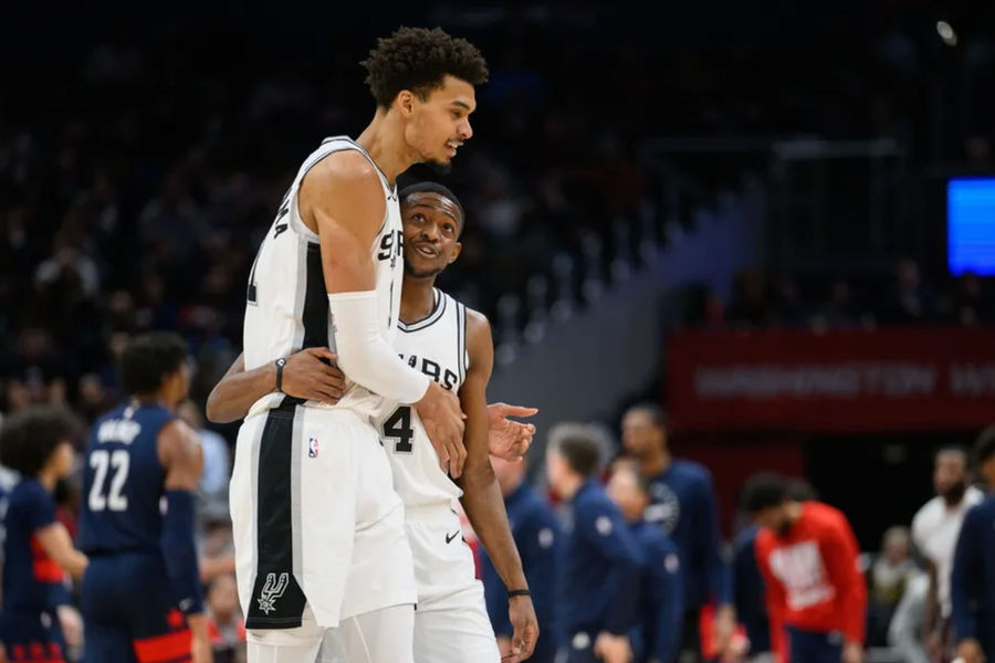 Feb 10, 2025; Washington, District of Columbia, USA; San Antonio Spurs center Victor Wembanyama (1) and guard De'Aaron Fox (4) react during the second quarter against the Washington Wizards at Capital One Arena. Mandatory Credit: Reggie Hildred-Imagn Images