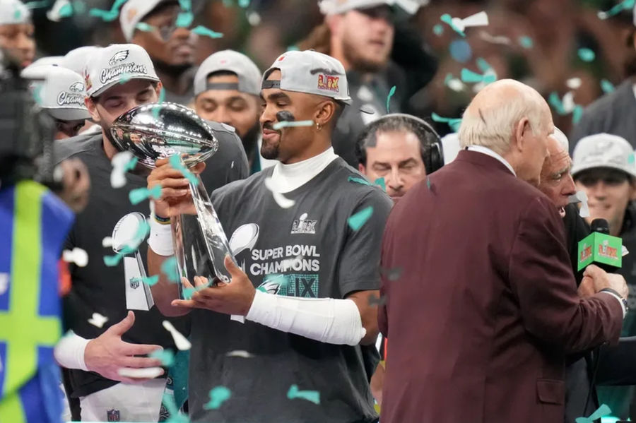 Feb 9, 2025; New Orleans, LA, USA; Philadelphia Eagles quarterback Jalen Hurts (1) hoists the Vince Lombardi Trophy after defeating the Kansas City Chiefs in Super Bowl LIX at Ceasars Superdome. Mandatory Credit: Kirby Lee-Imagn Images