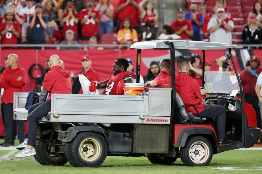 Oct 21, 2024; Tampa, Florida, USA; Tampa Bay Buccaneers wide receiver Chris Godwin (14) is carted off the field after an apparent injury against the Baltimore Ravens during the second half at Raymond James Stadium. Mandatory Credit: Kim Klement Neitzel-Imagn Images